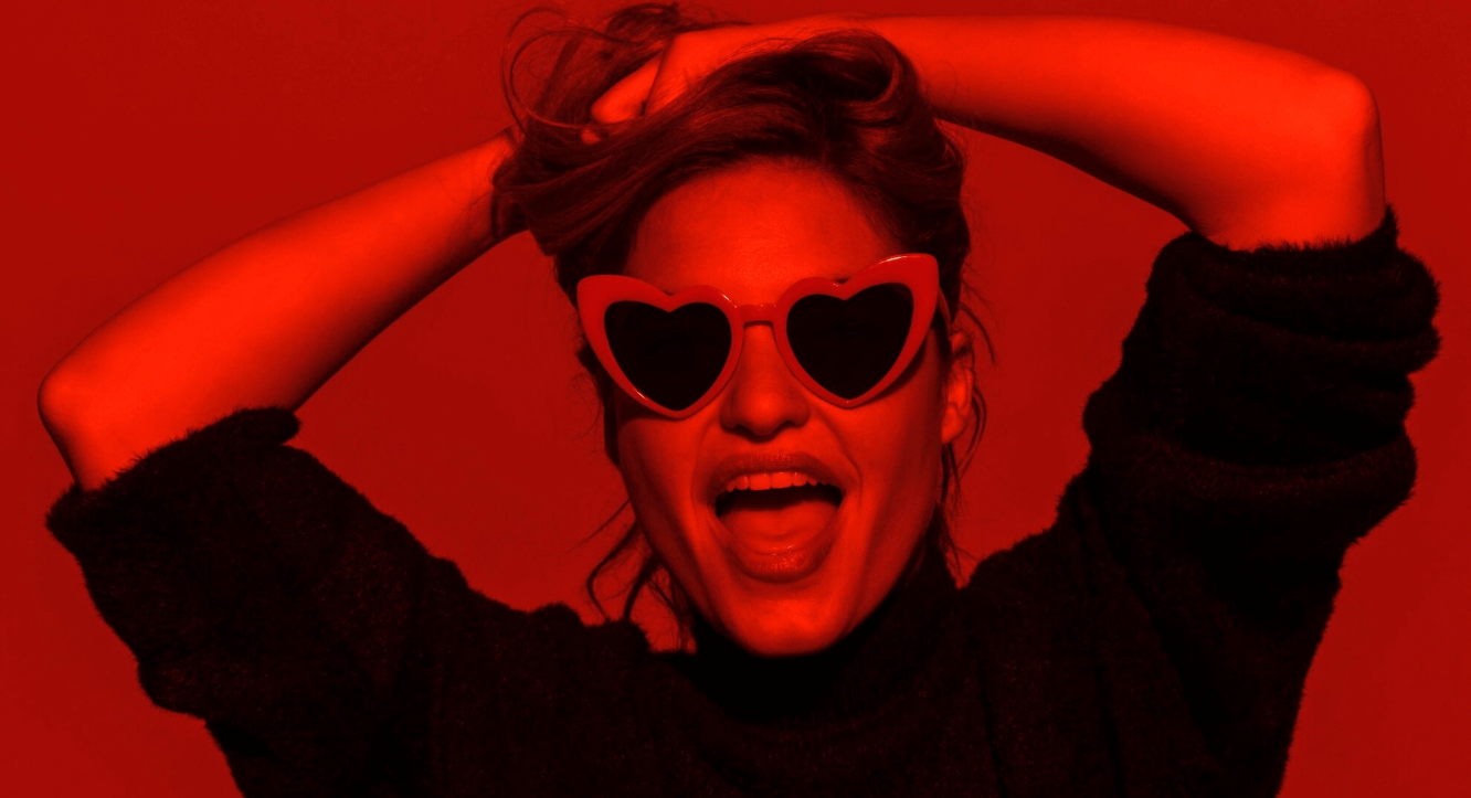 Red-lit editorial portrait used on the StreaMate BDSM cams page
